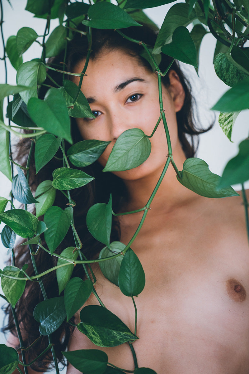 naked woman behind leaves