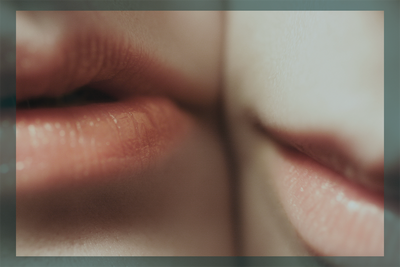 two women with lips close together